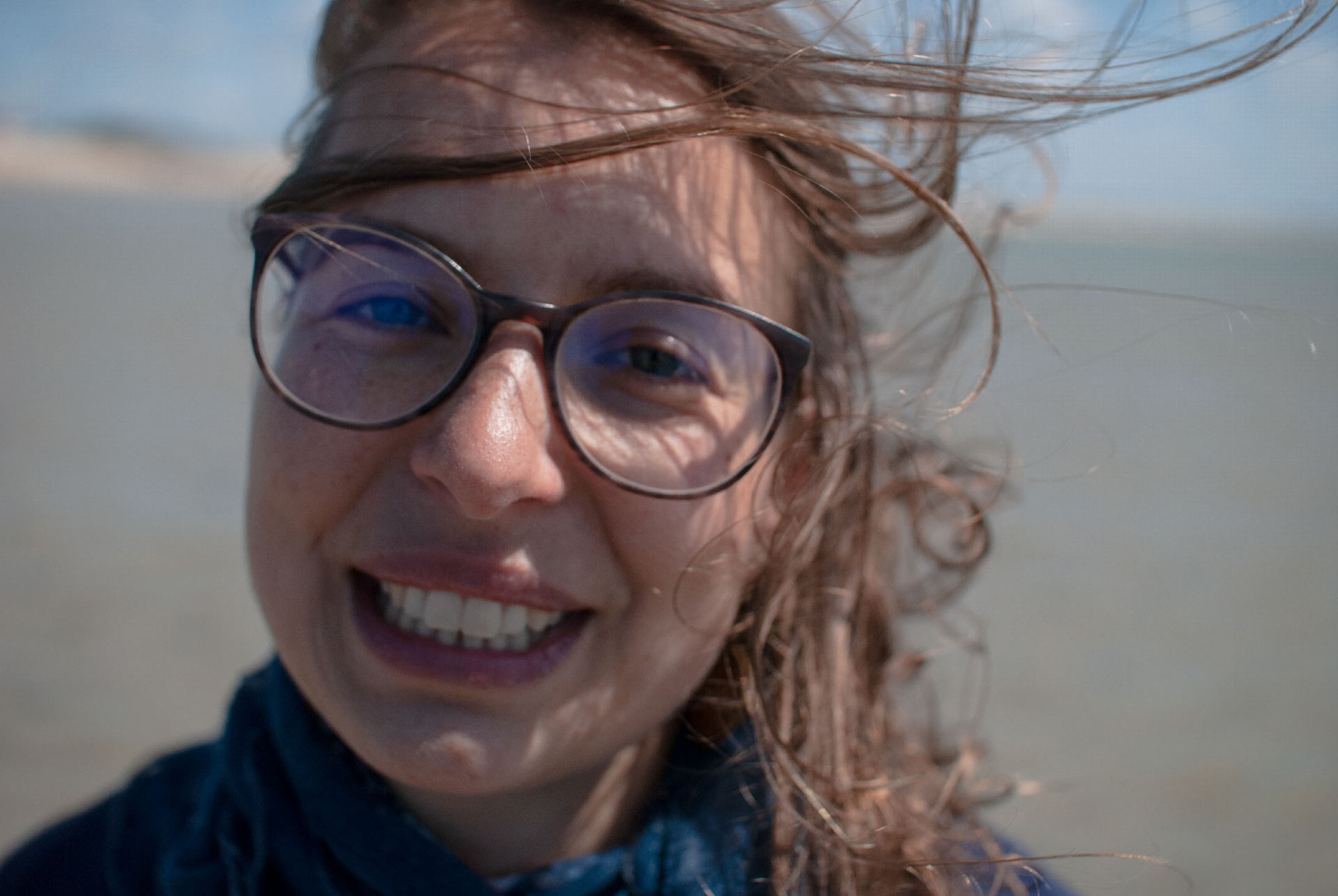 the-lovely-face-of-a-young-woman-smiling-at-you-with-the-wind-in-her-hear